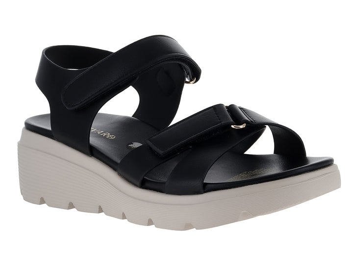 Sandalia negra de plataforma blanca con correas ajustables de velcro para mujer.