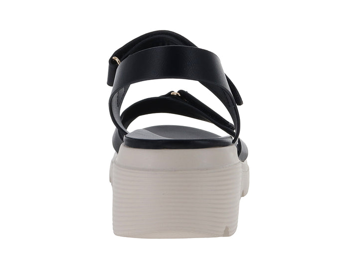 Sandalia negra de plataforma blanca con correas ajustables de velcro para mujer.