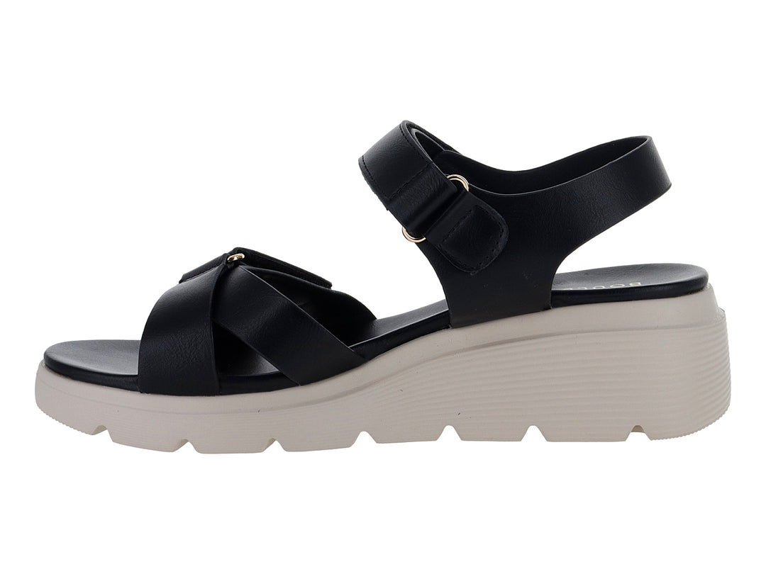 Sandalia negra de plataforma blanca con correas ajustables de velcro para mujer.