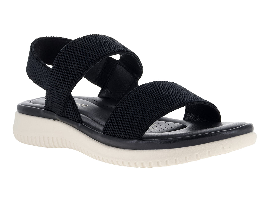 Sandalia negra con correas de tela tejida y suela blanca gruesa.