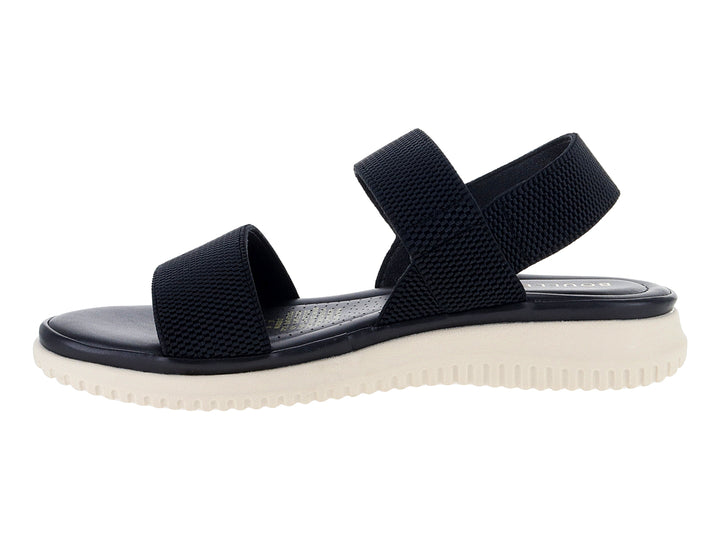 Sandalia negra con correas de tela tejida y suela blanca gruesa.