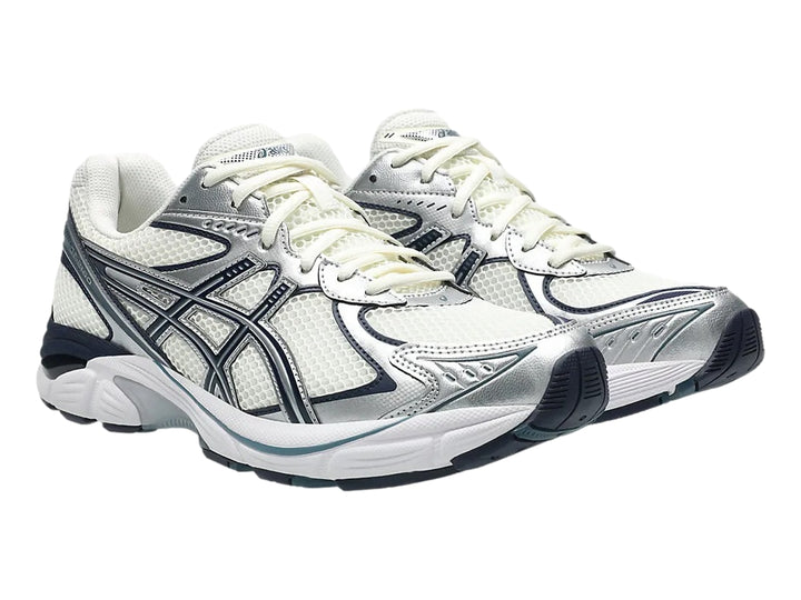 Tenis deportivos ASICS GT-2160 color crema con detalles en azul marino y plata.