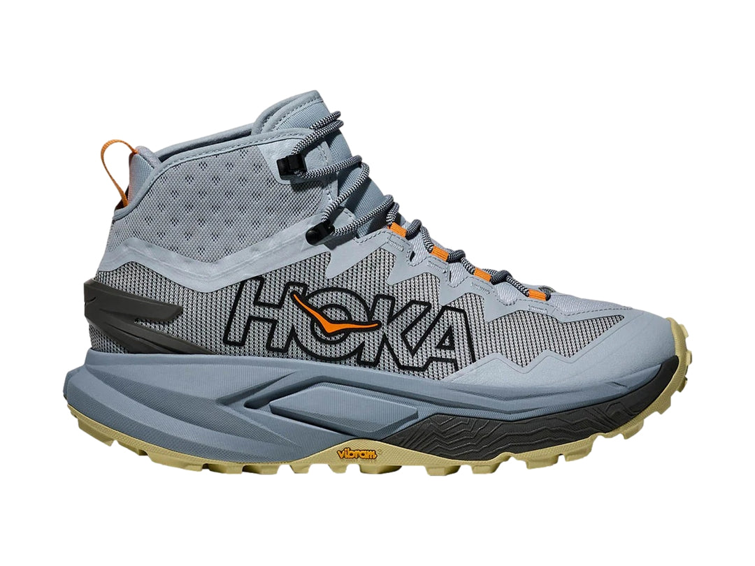 Botín de senderismo HOKA Mafate Hike color azul mineral con detalles en naranja y suela beige.