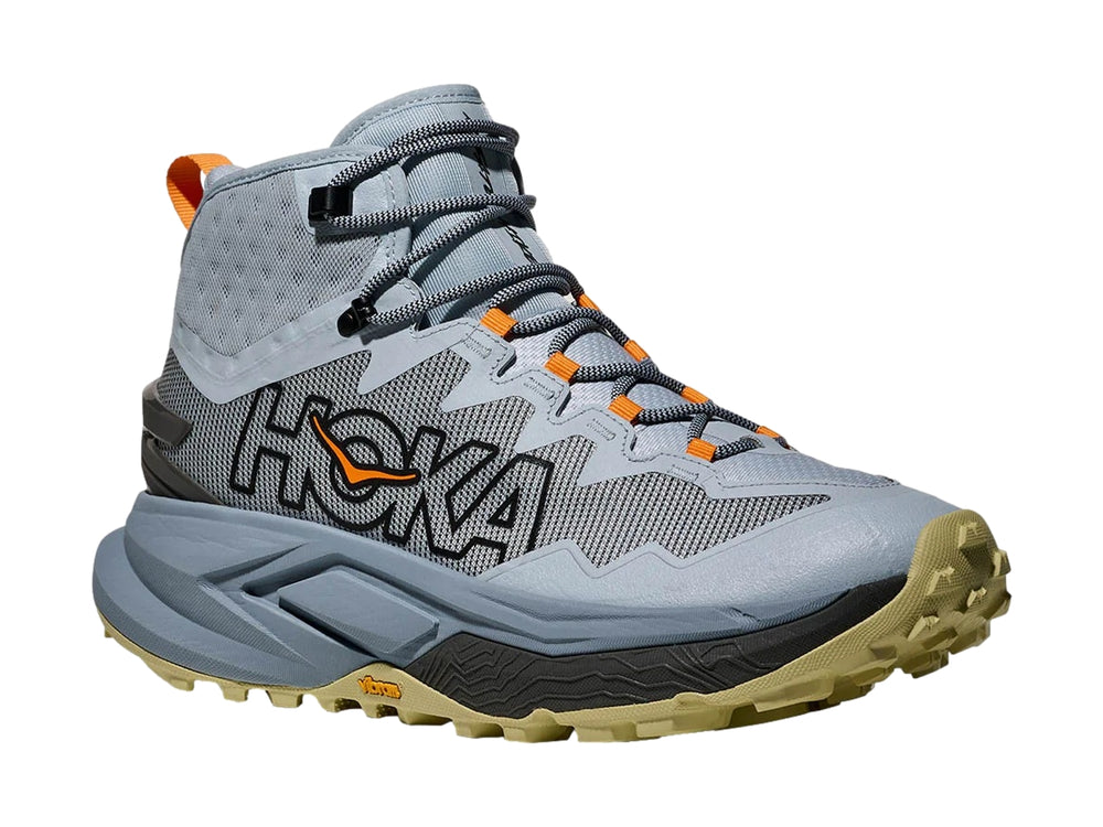Botín de senderismo HOKA Mafate Hike color azul mineral con detalles en naranja y suela beige.