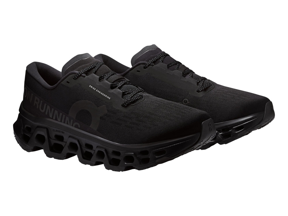Tenis deportivos On Cloudmonster 3 color negro con suela de amortiguación característica.