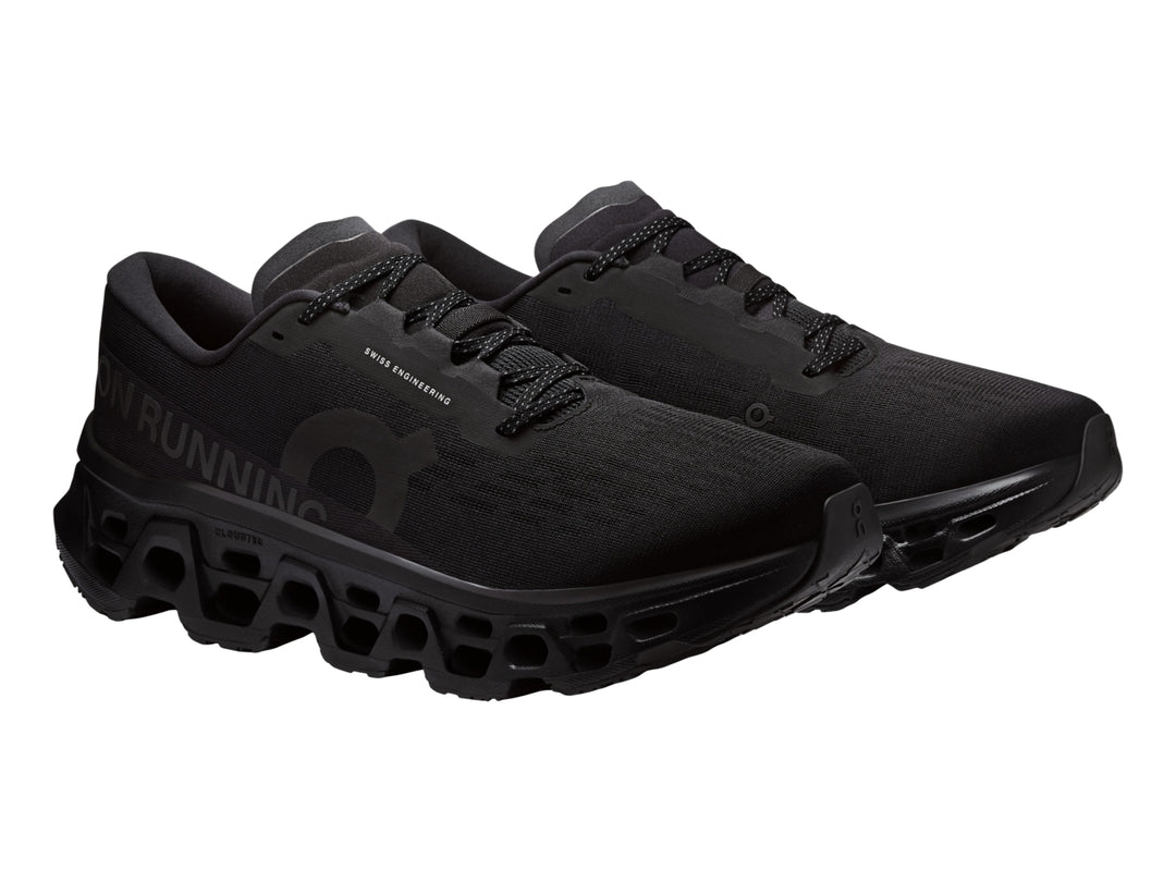 Tenis deportivos On Cloudmonster 3 color negro con suela de amortiguación característica.