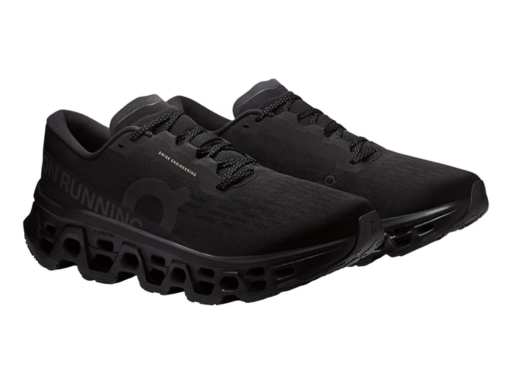 Tenis deportivos On Cloudmonster 3 color negro con suela de amortiguación característica.