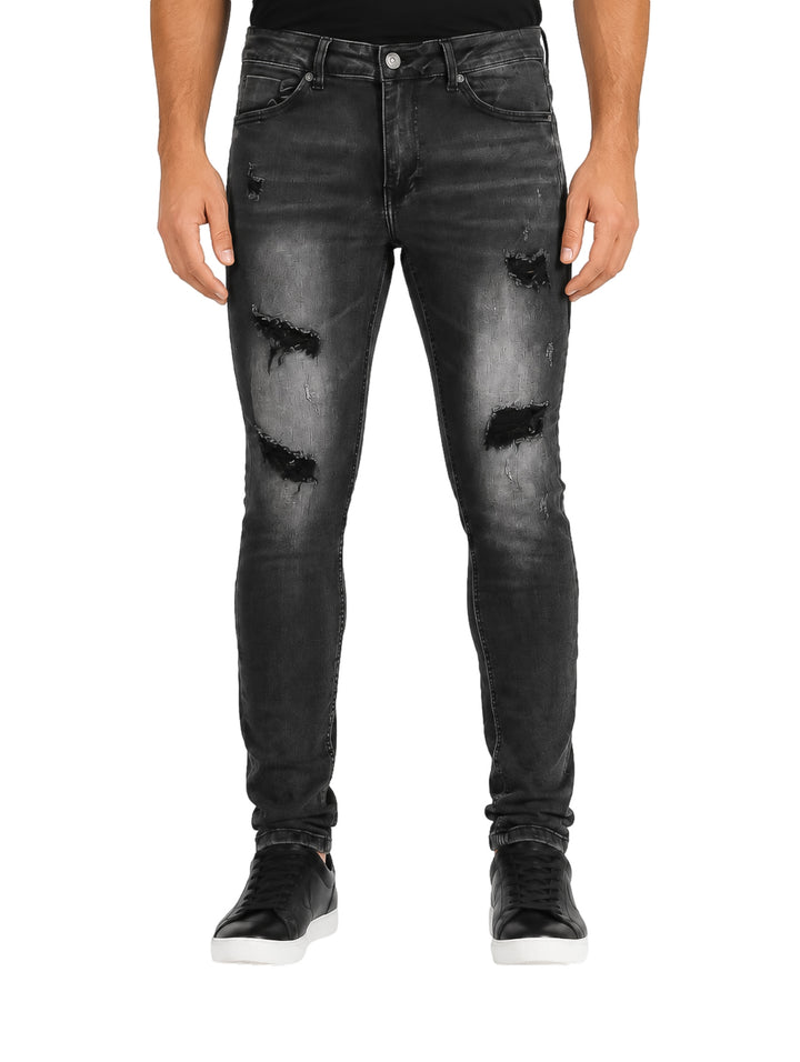 Jeans color negro para hombre con efecto desgastado y corte ajustado.