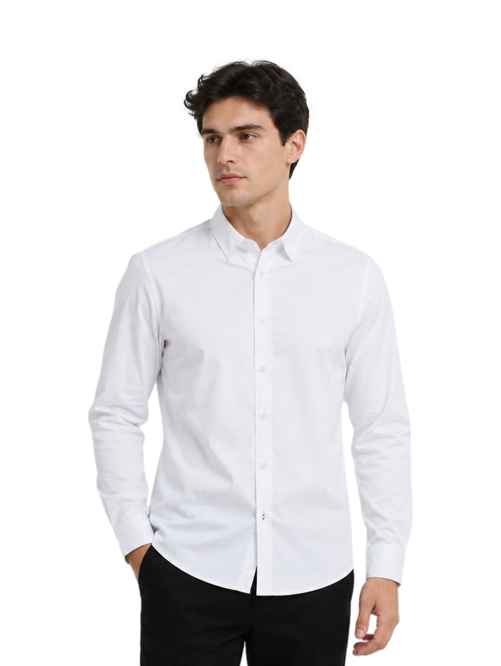 Hombre vistiendo una camisa blanca de manga larga y cuello, estilo elegante.