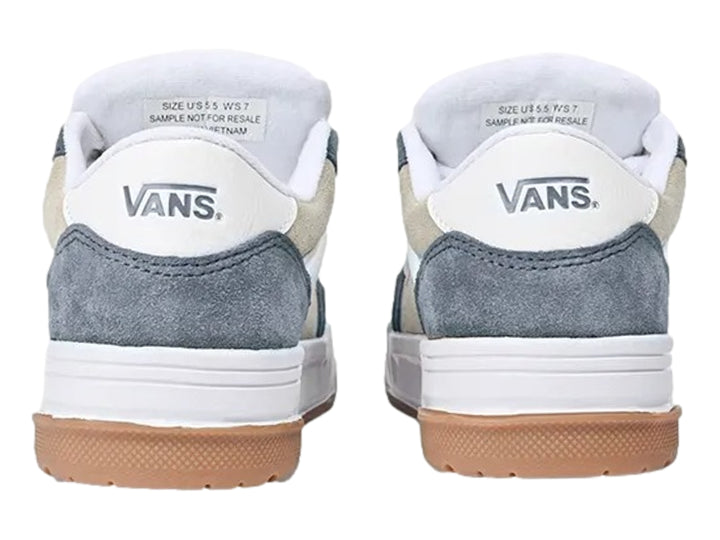 Tenis Vans color azul y crema con suela de goma marrón y cordones blancos.