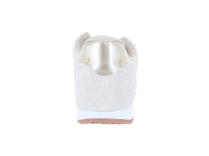 Tenis ATOK color hielo con suela blanca y detalle brillante en el talón.