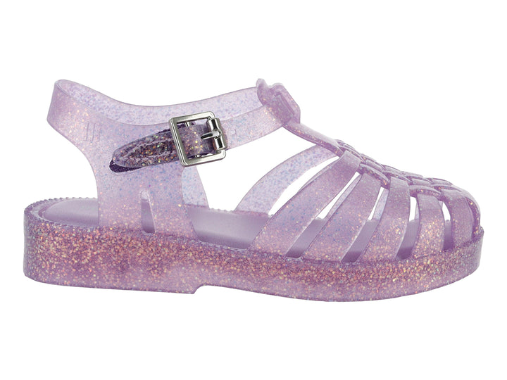 Sandalia morada con glitter para bebé de la marca Mini Melissa, con diseño calado y correa con hebilla.