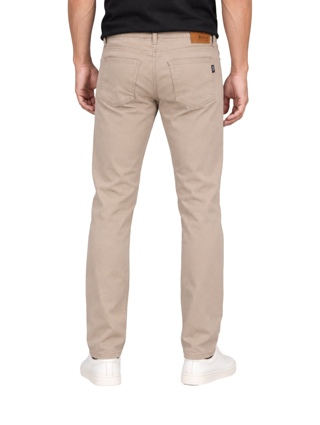 Hombre vistiendo un pantalón OGGI color khaki de corte recto y calzado blanco sobre fondo blanco.
