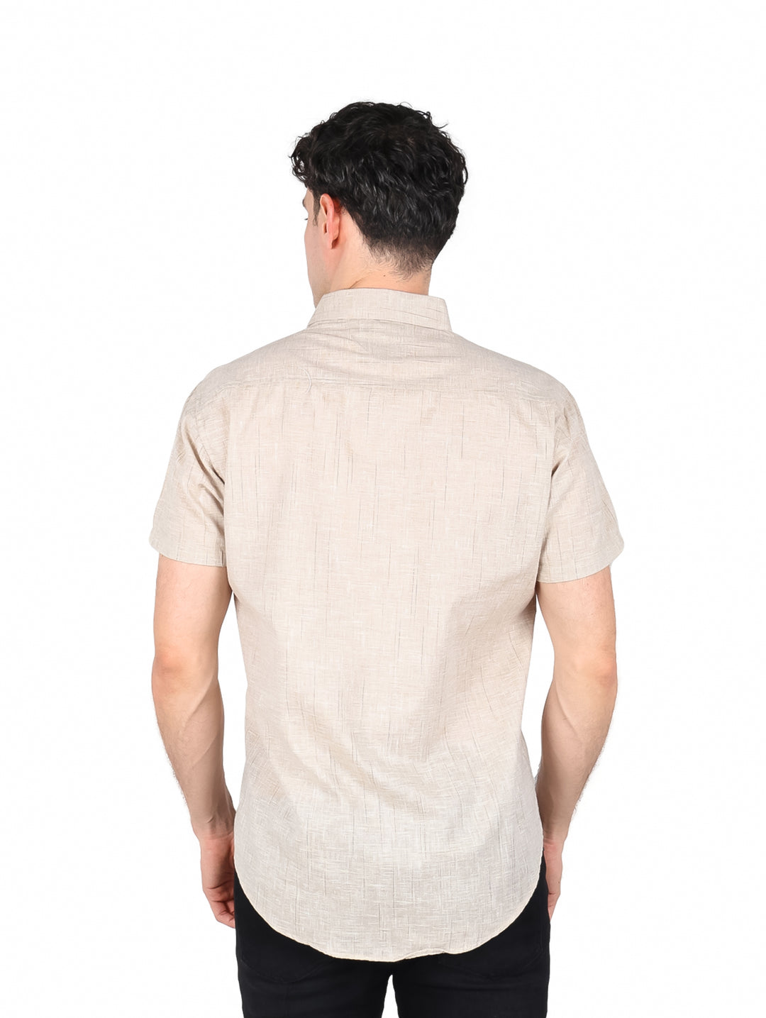 Hombre vistiendo una camisa de manga corta color beige con botones frontales.