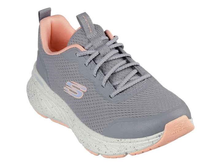 Tenis deportivos Skechers en color gris con detalles en coral y suela blanca moteada para mujer.
