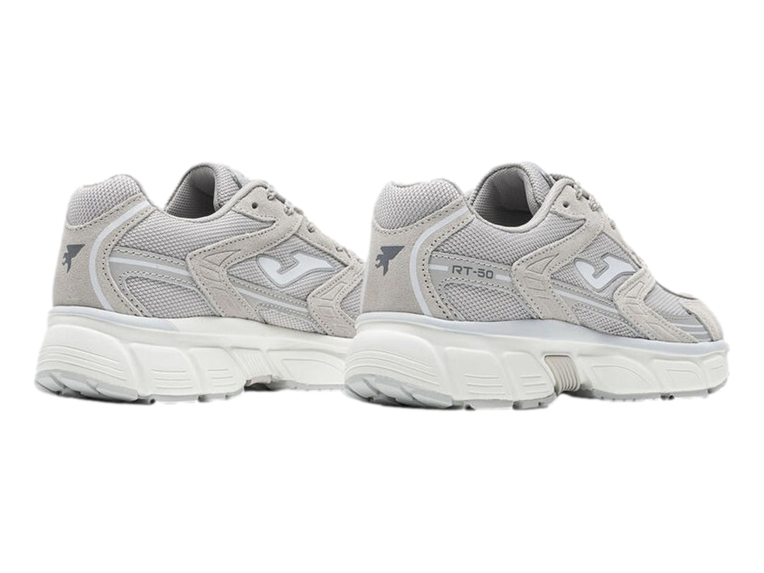 Tenis deportivos Joma modelo RT50 en color gris con detalles blancos y suela blanca robusta para mujer.