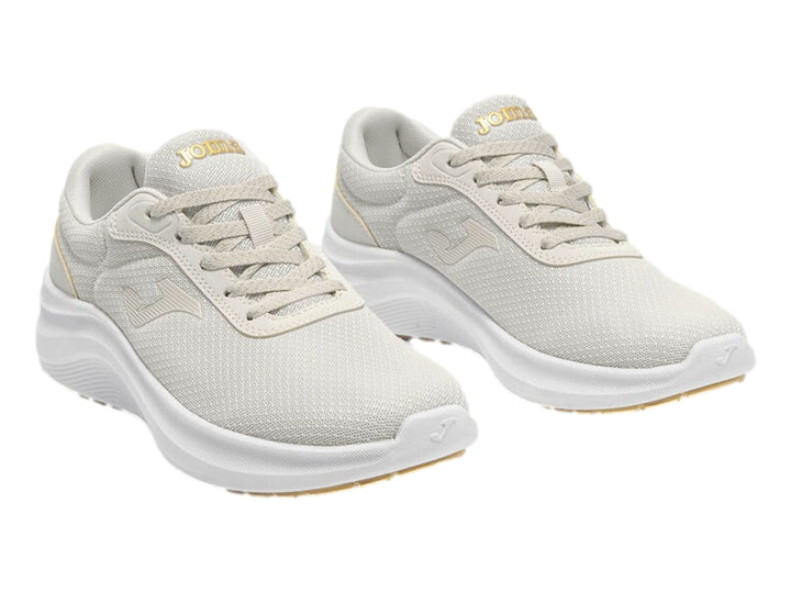 Tenis deportivos Joma para mujer en color blanco con suela blanca y tejido transpirable.