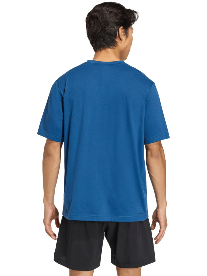 Hombre vistiendo una camiseta deportiva azul de manga corta con logo de Adidas en el pecho.