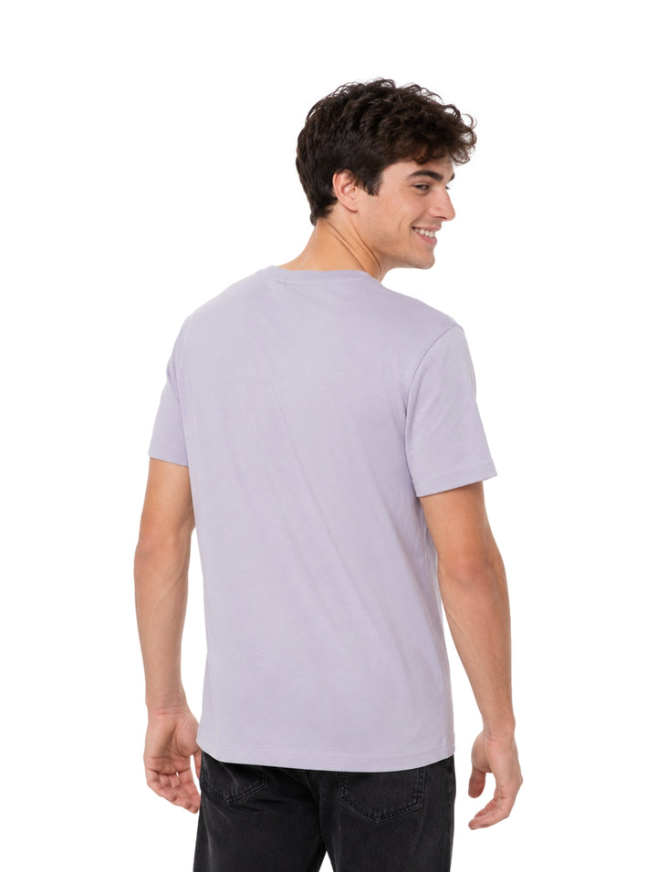 Hombre vistiendo playera Hurley color gris claro Light Asteroid de manga corta y cuello redondo.