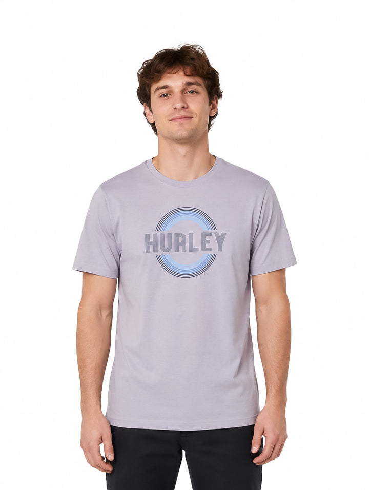 Hombre vistiendo playera Hurley color navy con gráfico circular en el pecho.