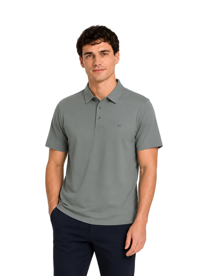 Hombre vistiendo una playera polo Hurley color gris oxford de manga corta.