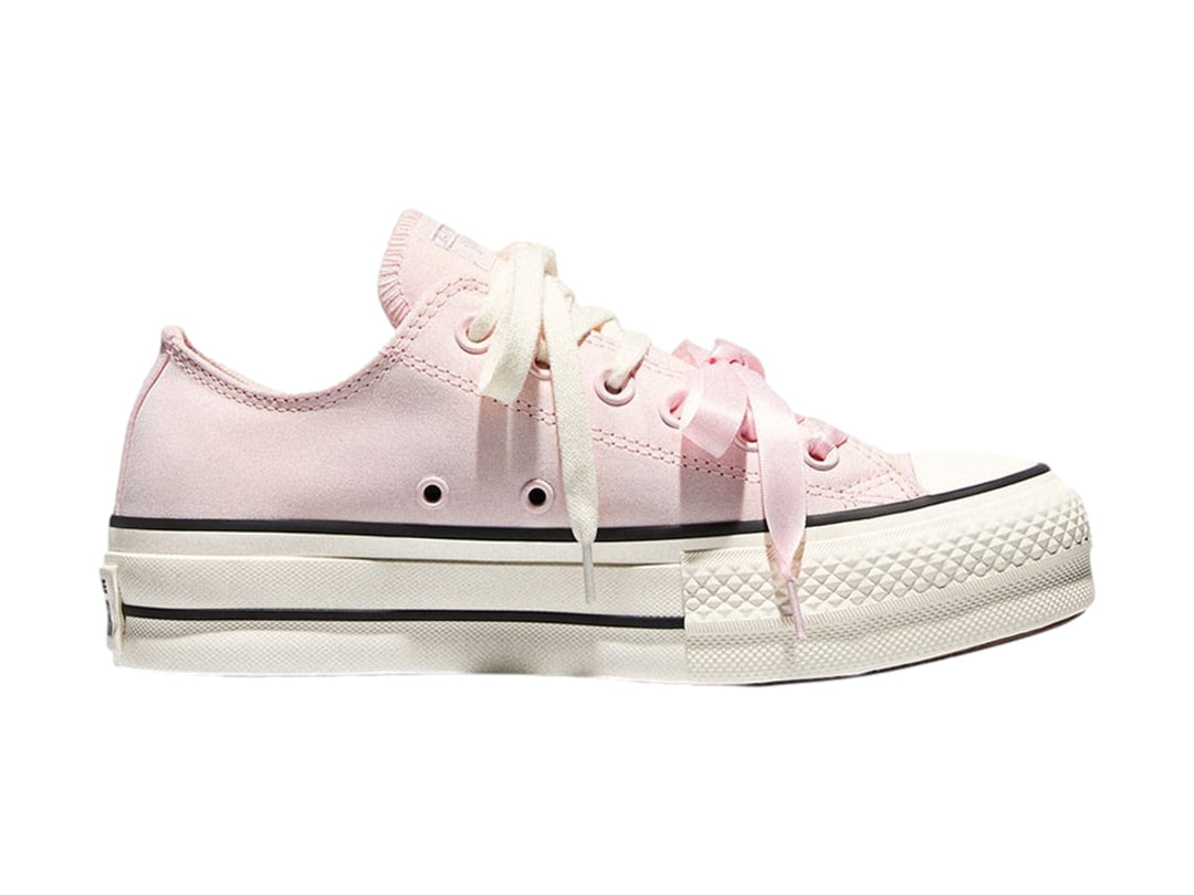 Tenis Converse de plataforma color rosa con suela blanca y franjas negras laterales.