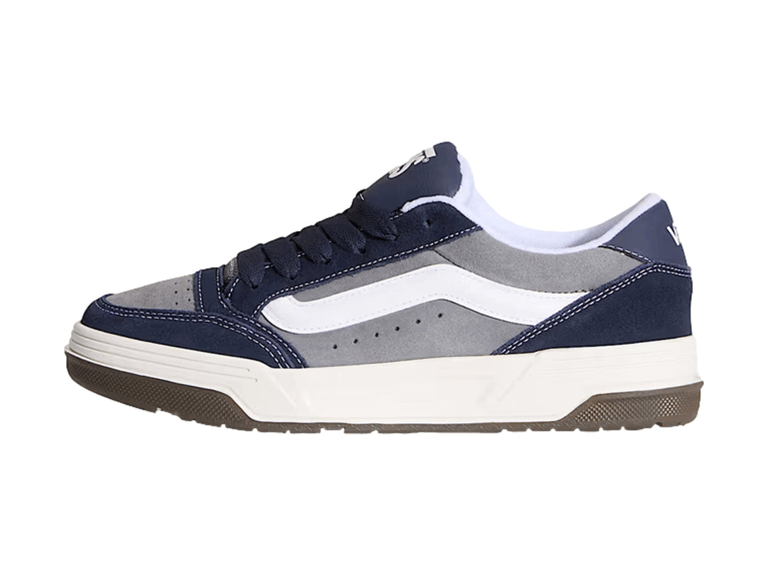 Tenis Vans Hylane en colores gris y azul marino con franja blanca y suela de goma marrón.