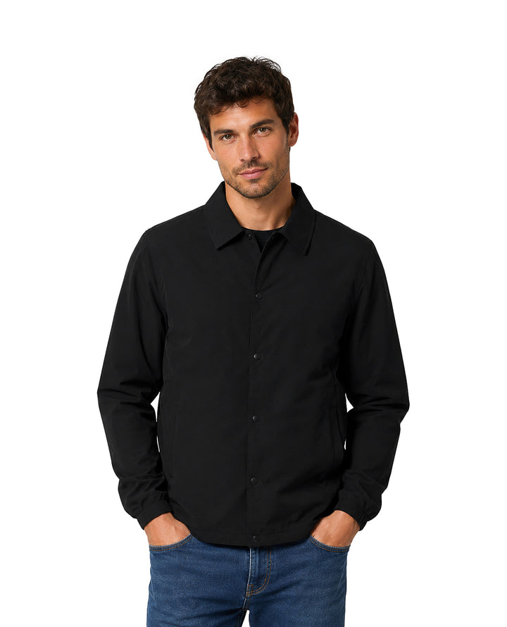 Hombre vistiendo una camisa negra de manga larga con cuello y botones.