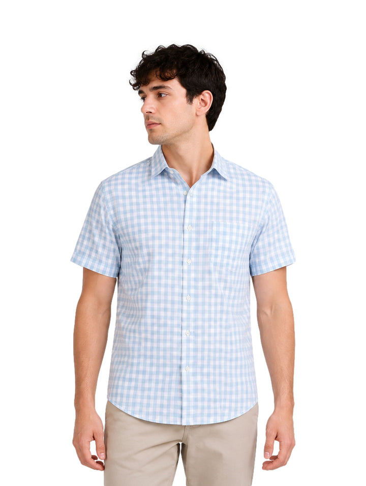Hombre vistiendo camisa de manga corta con estampado de cuadros azul claro y blanco.