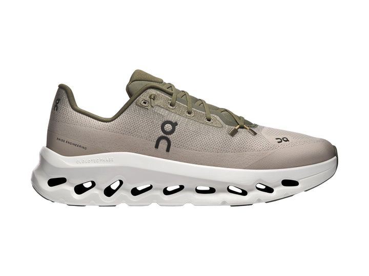 Tenis deportivos On Cloud color oliva con suela blanca y diseño moderno.