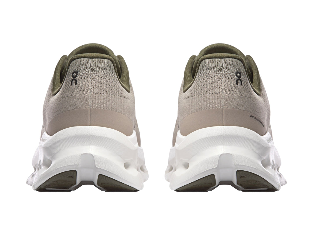 Tenis deportivos On Cloud color oliva con suela blanca y diseño moderno.