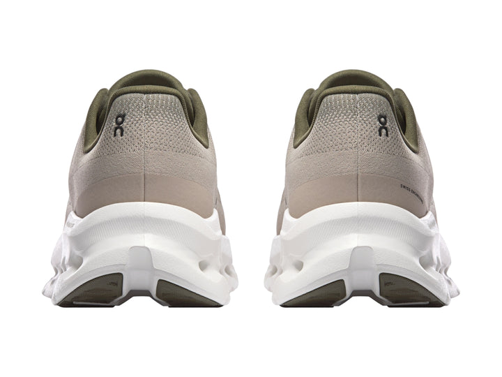 Tenis deportivos On Cloud color oliva con suela blanca y diseño moderno.