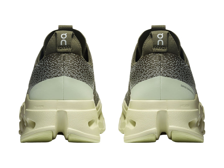 Tenis deportivos On Cloud color verde oliva con suela gruesa y perforada en tono verde claro.