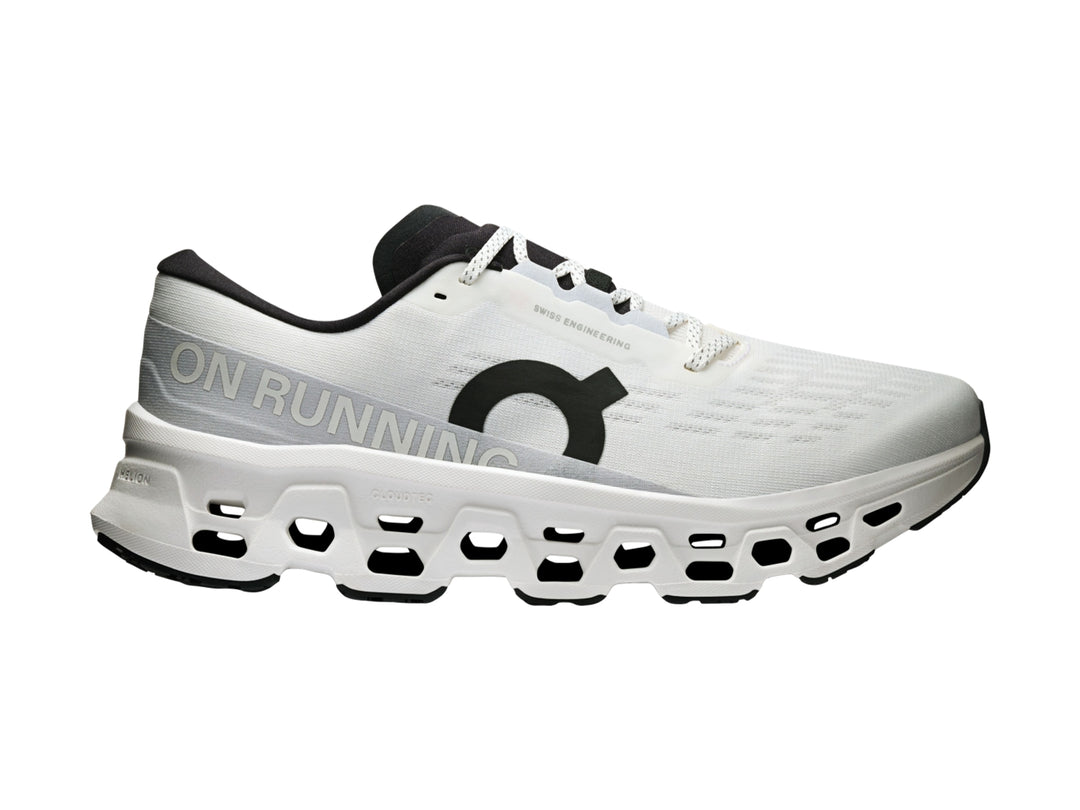 Tenis deportivos On Cloud Cloudmonster 3 color blanco con detalles negros y suela con tecnología de amortiguación.