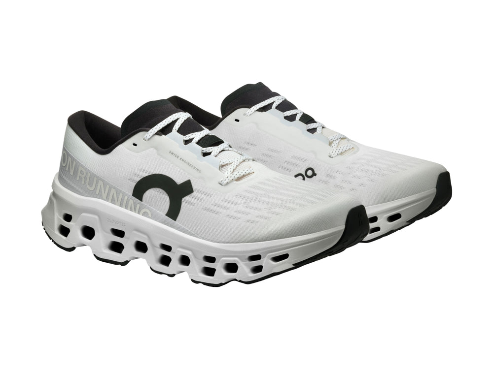 Tenis deportivos On Cloud Cloudmonster 3 color blanco con detalles negros y suela con tecnología de amortiguación.