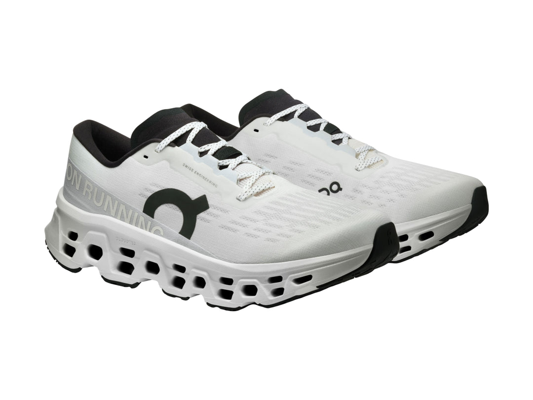Tenis deportivos On Cloud Cloudmonster 3 color blanco con detalles negros y suela con tecnología de amortiguación.