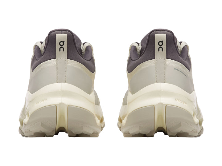Tenis deportivos On Cloud color beige con suela gruesa y cuello en color gris oscuro.