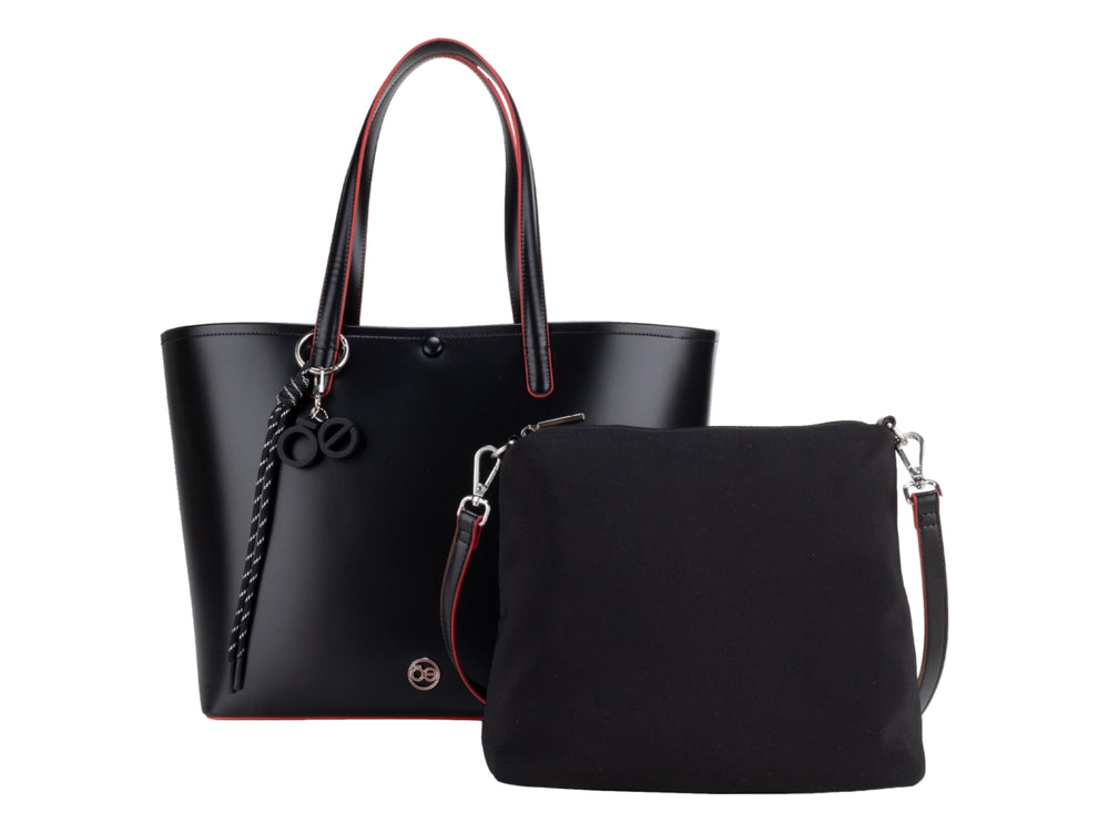 Bolsa tote color negro con bordes rojos y accesorio de borla decorativa, marca Cloe.