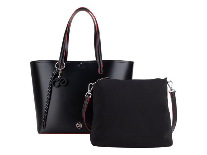 Bolsa tote color negro con bordes rojos y accesorio de borla decorativa, marca Cloe.