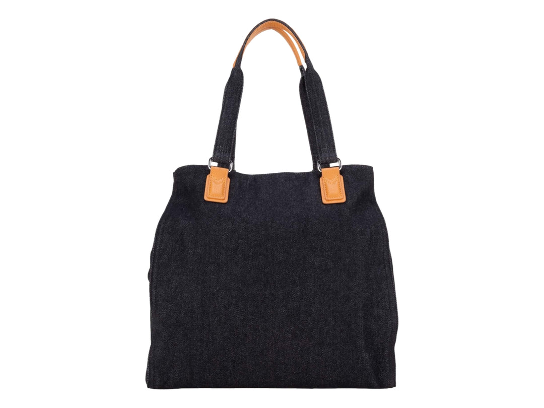 Bolsa tote color negro con detalles y asas en color naranja.