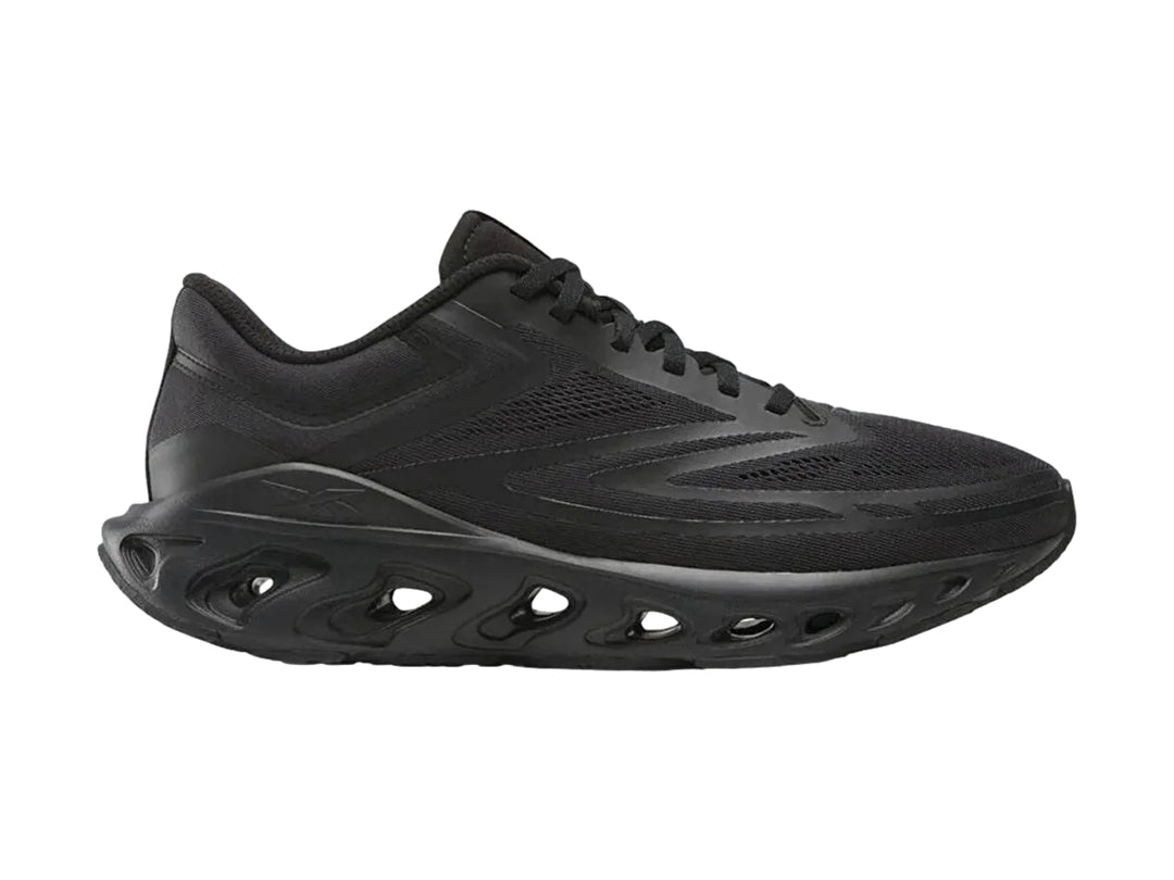 Tenis deportivos Reebok Fuel Flex Run color negro con suela perforada y malla transpirable.