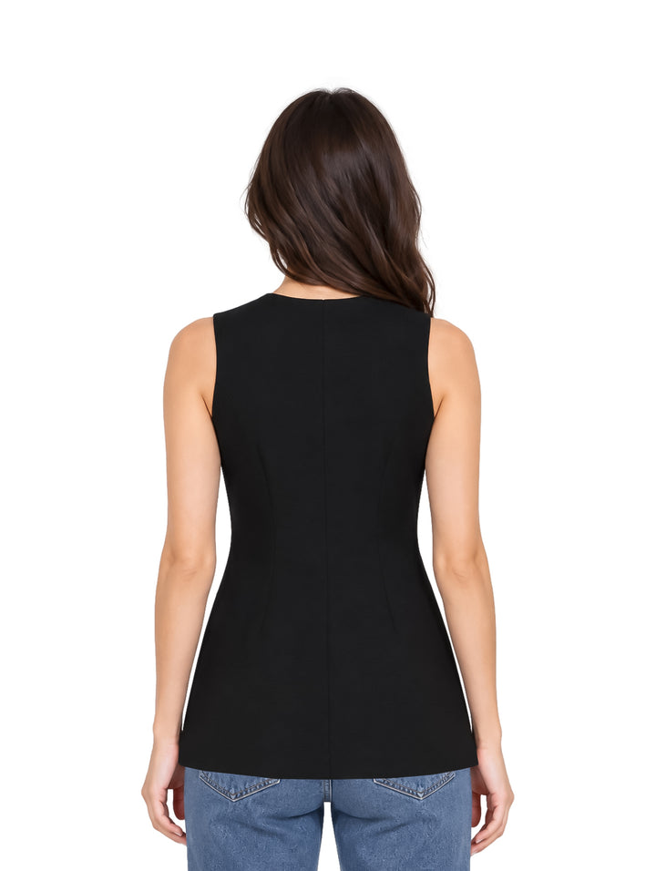 Mujer vistiendo un vestido corto sin mangas color negro con botones frontales dorados.