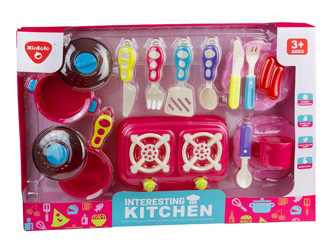 Set de cocina de juguete color rosa con estufa, ollas y utensilios en empaque transparente.