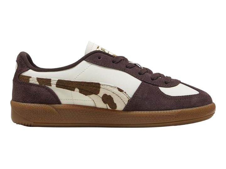 Tenis PUMA Palermo en color blanco y marrón chocolate con estampado de vaca y suela de goma.