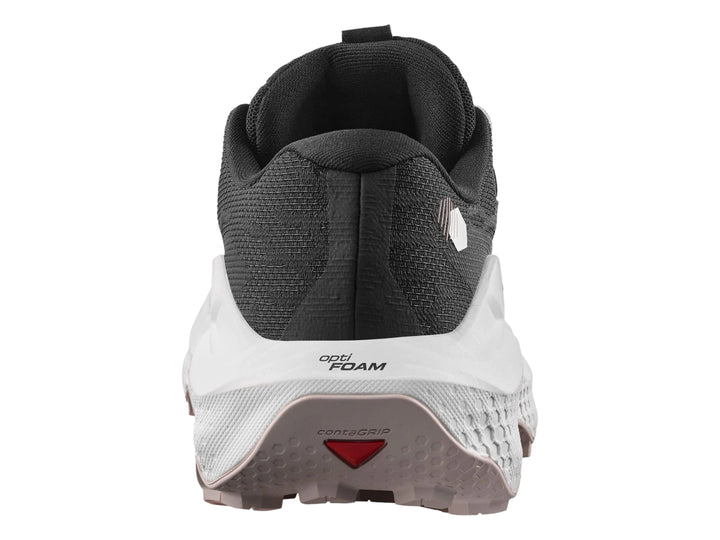 Tenis deportivos Salomon Ultra Glide 4 color negro con suela blanca y detalles en rosa pálido.