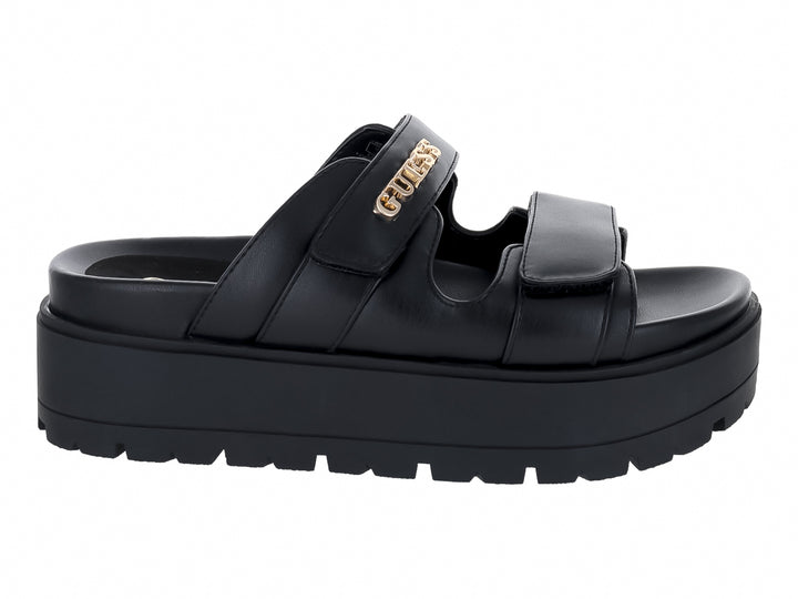 Sandalias de plataforma color negro marca GUESS con suela gruesa y correas ajustables.