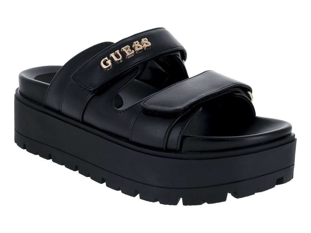 Sandalias de plataforma color negro marca GUESS con suela gruesa y correas ajustables.