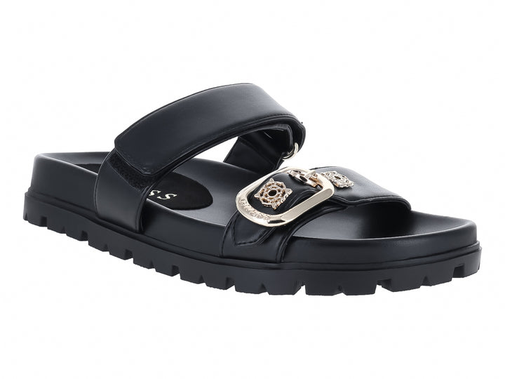 Sandalias negras Guess con suela track gruesa y hebilla dorada decorativa.