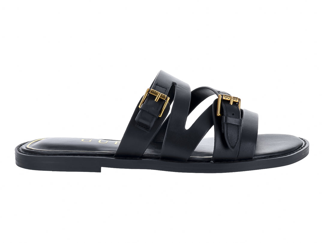 Sandalias planas negras con tiras y hebillas doradas de la marca GUESS.