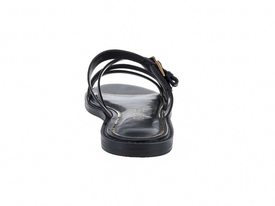Sandalias planas negras con tiras y hebillas doradas de la marca GUESS.